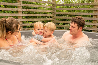 A family enjoying their wood fire hot tub