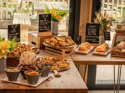 A table of banquet food including homemade sausage rolls and ciabatta sandwiches